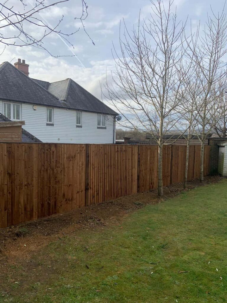 This is a photo of feather edge fencing installed in a residential properties garden by Fast Fix Fencing Newmarket
