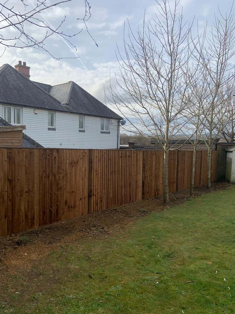 This is a photo of feather edge fencing installed in a residential properties garden by Fast Fix Fencing Newmarket