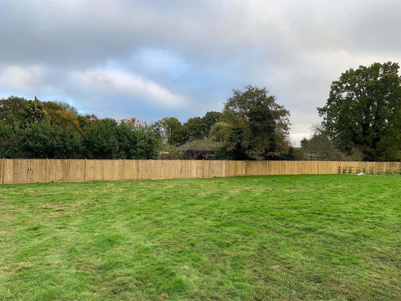 This is a photo of feather edge fencing installed around the edge of a field by Fast Fix Fencing Newmarket