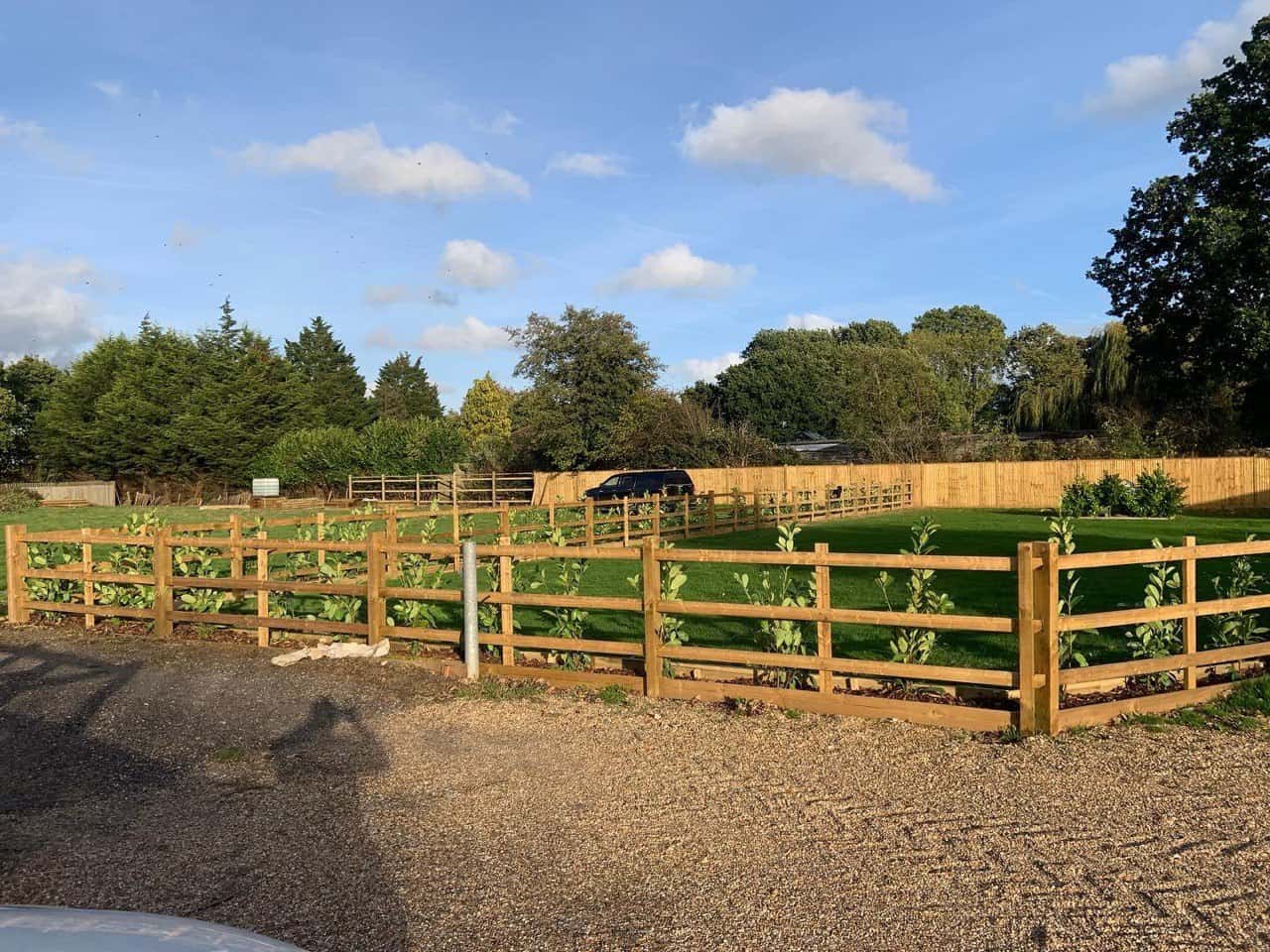 This is a photo of post and rail fencing with a gravel board installed at the base to create a flower bed, and at the rear is feather edge fencing along the edge of the garden. All works carried out by Fast Fix Fencing Newmarket